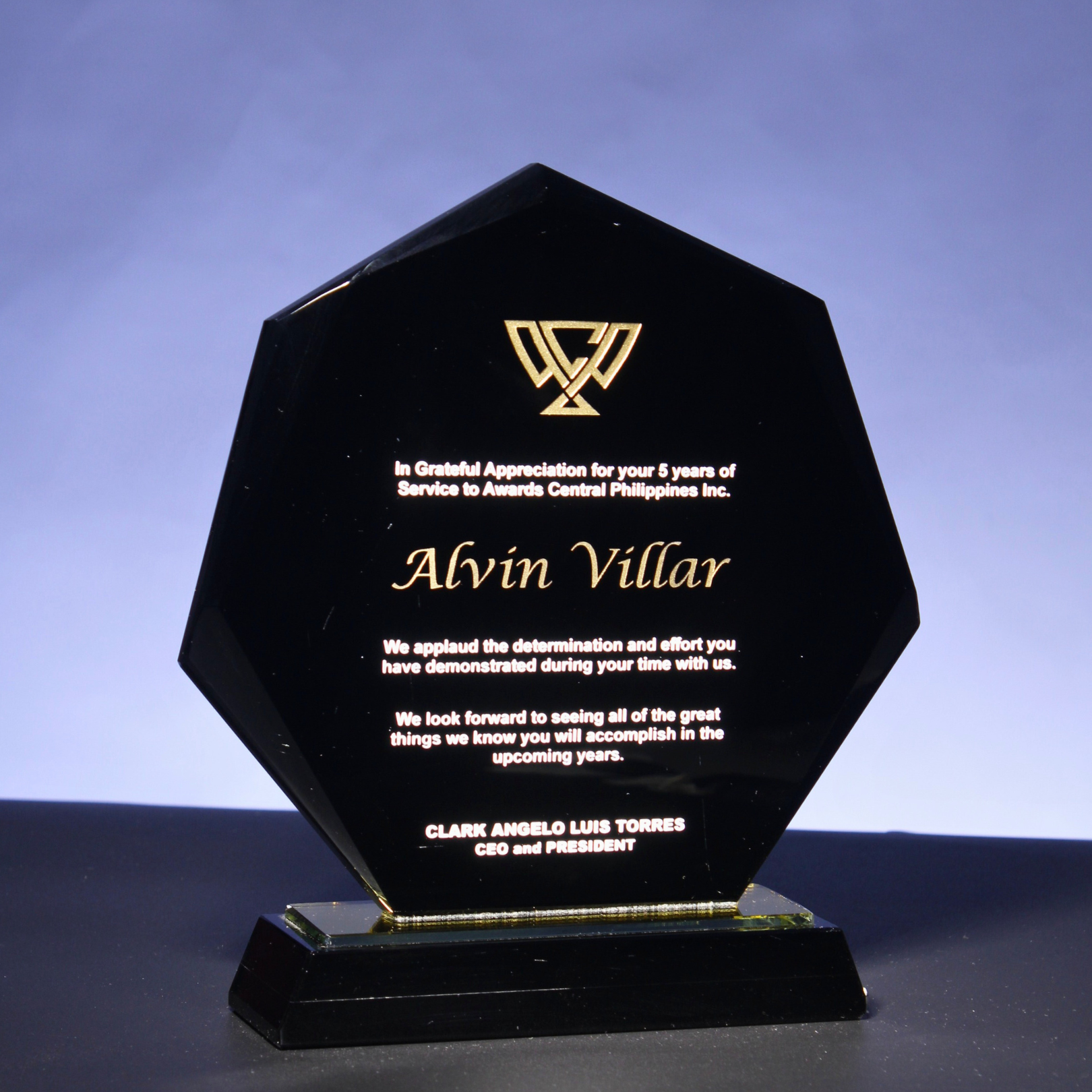 - This wide pentagonal obsidian glass plaque radiates grace and authority with smooth, confident curves. - The refined silhou