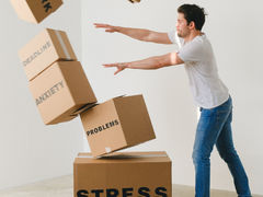 Man pushing boxes labelled with issues