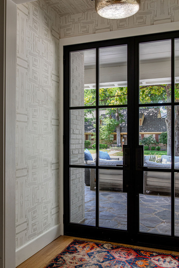 iron French doors with wallpaper