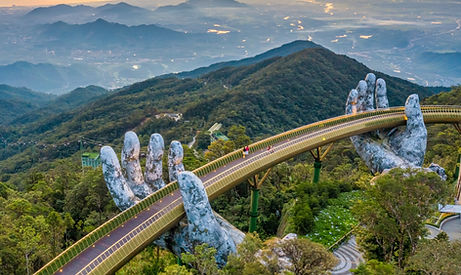 A bridge with people on it supported by two giant hands made of rock