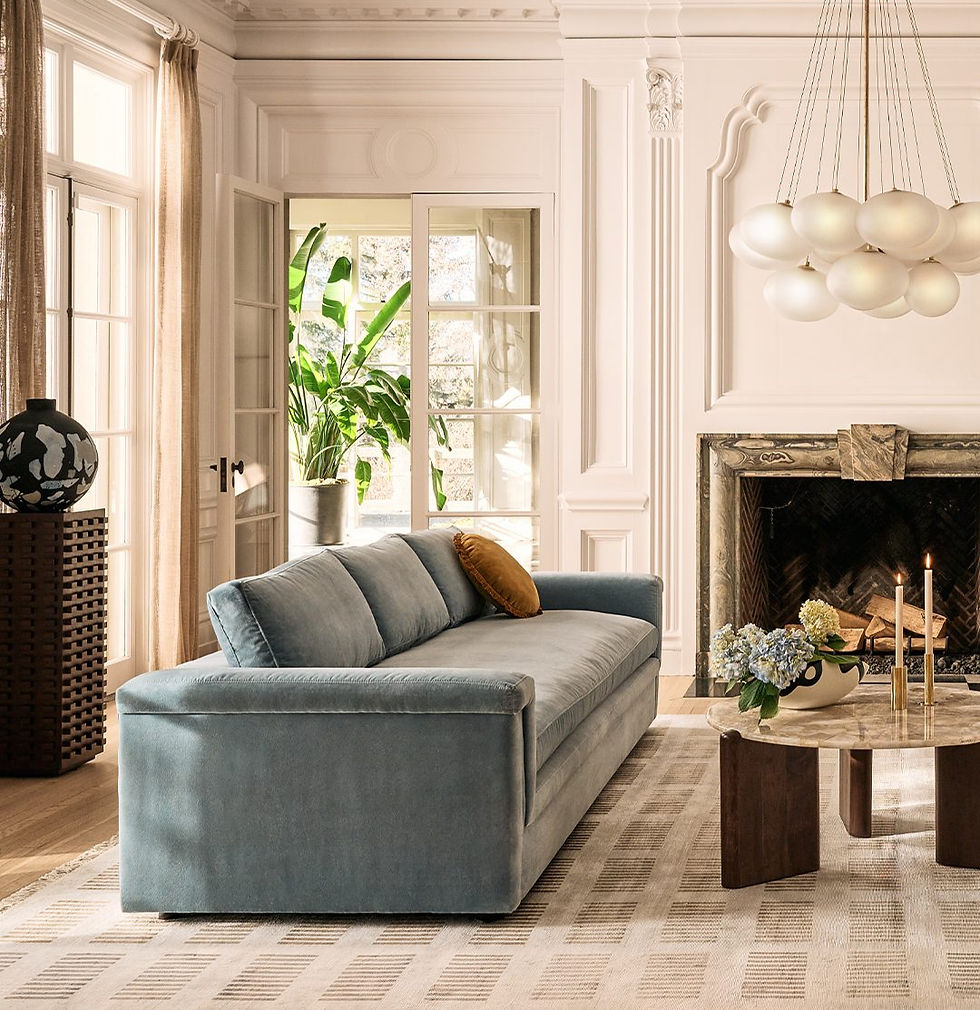 Living room with modular sofa, fireplace, and sculptural pendant lighting