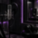 Professional microphone and headphones in a studio with purple lighting