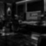 Modern music production studio with desk and monitors.