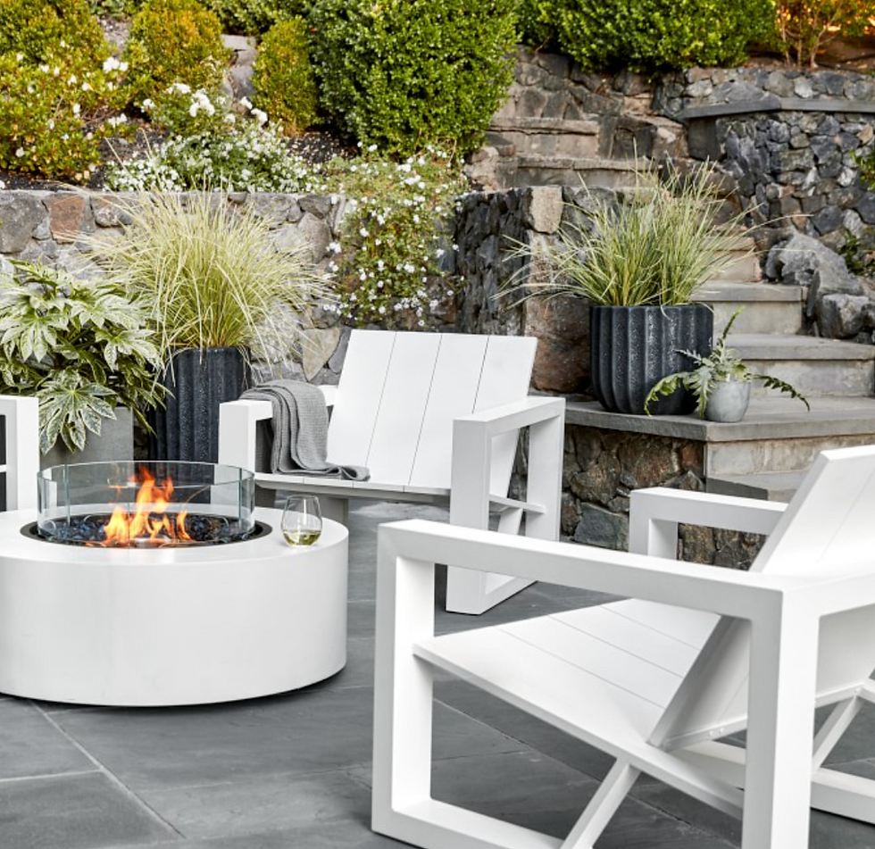 Fluted outdoor Maris planters on patio with plants by Williams Sonoma.