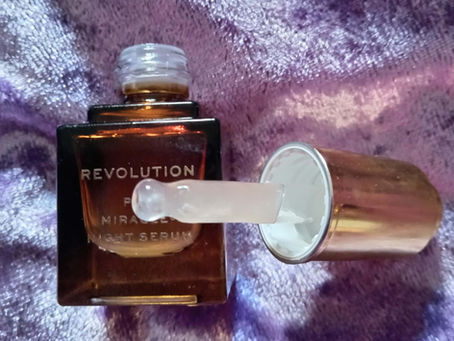 Revolution Pro Miracle Night Rescue Serum with dropper on a purple brushed velvet background