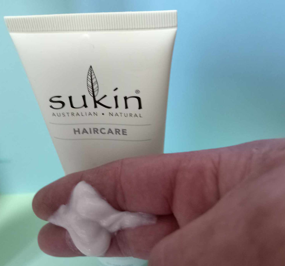 Scalp scrub formula shown on fingers