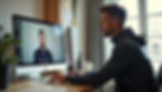 Man in a hoodie video calls on a desktop in a cozy room with plants and medals. Bright daylight through a window creates a focused mood.