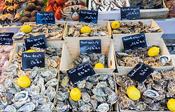 Various types of oysters at a local fish market, France.jpg