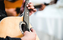 Close up of the guitar of a man playing traditional Portuguese music called fado 
