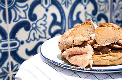 Traditional portuguese Sandwich bifana over traditional portuguese background tiles azulej