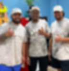 Lui, Tre, and Vito are standing side by side, wearing grey Waves Restaurant t-shirts