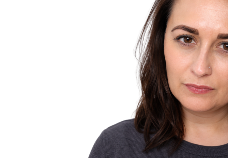 Catherine Hodgson wearing a grey t-shirt standing in front of a white background
