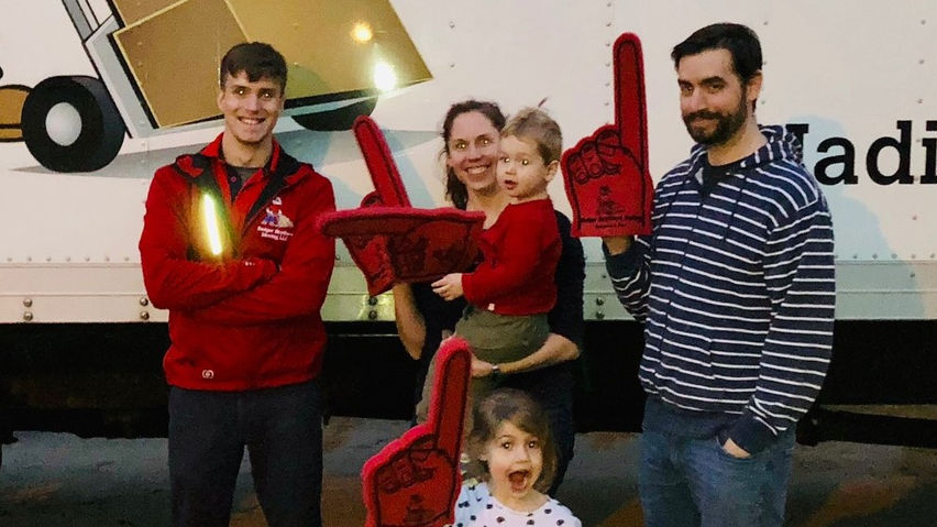 Happy customers with our Wisconsin movers at dusk