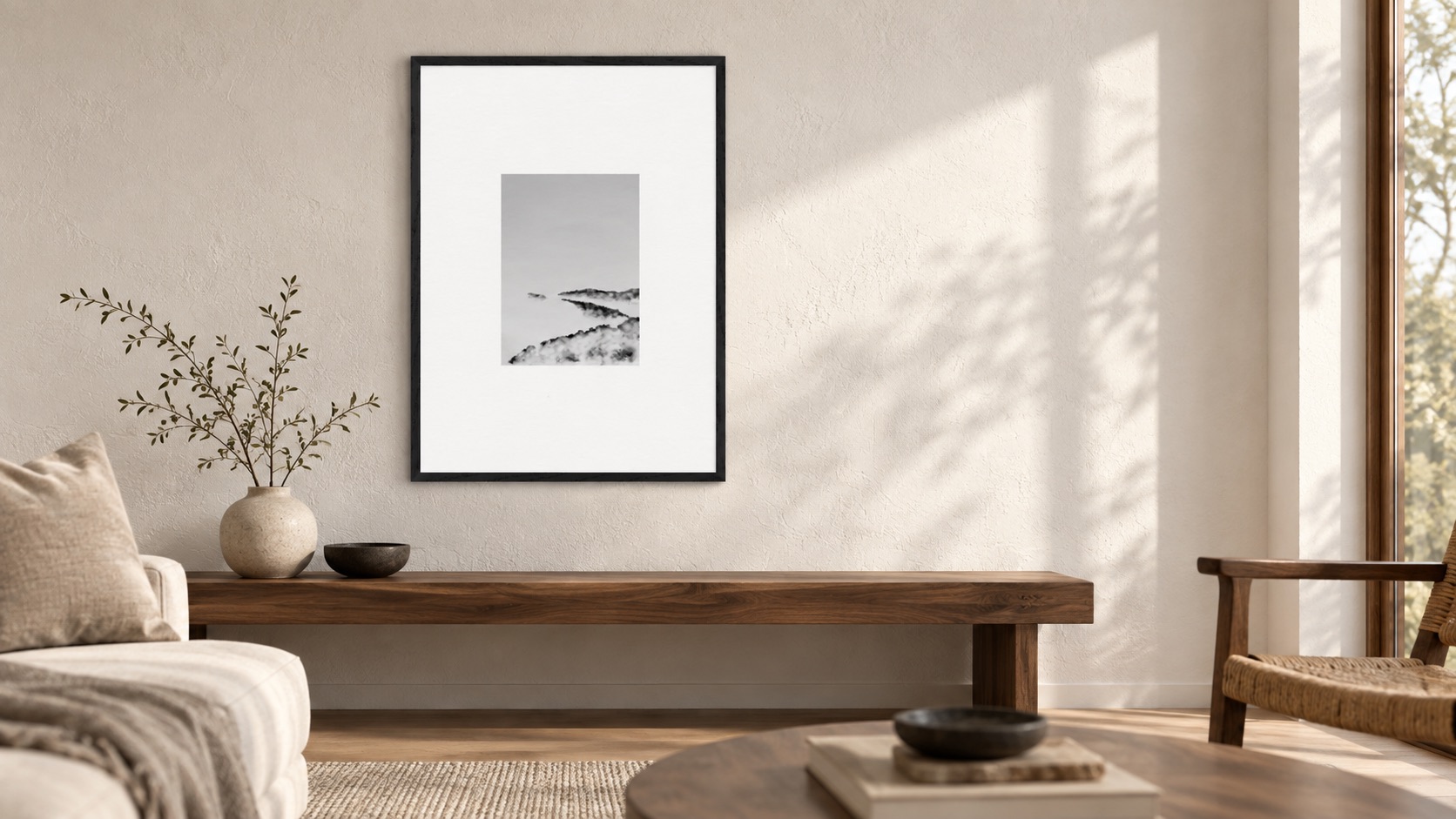 Cloud Layers Study, a framed black-and-white cloud landscape print, above a walnut bench in a calm warm-neutral living room.