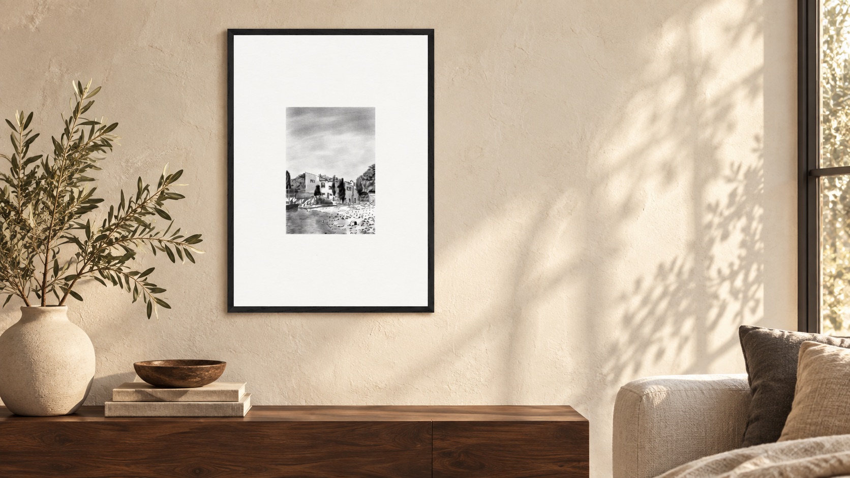 Portlligat House Study framed black and white architectural print in a warm Mediterranean-inspired living room with a walnut console and olive branches.