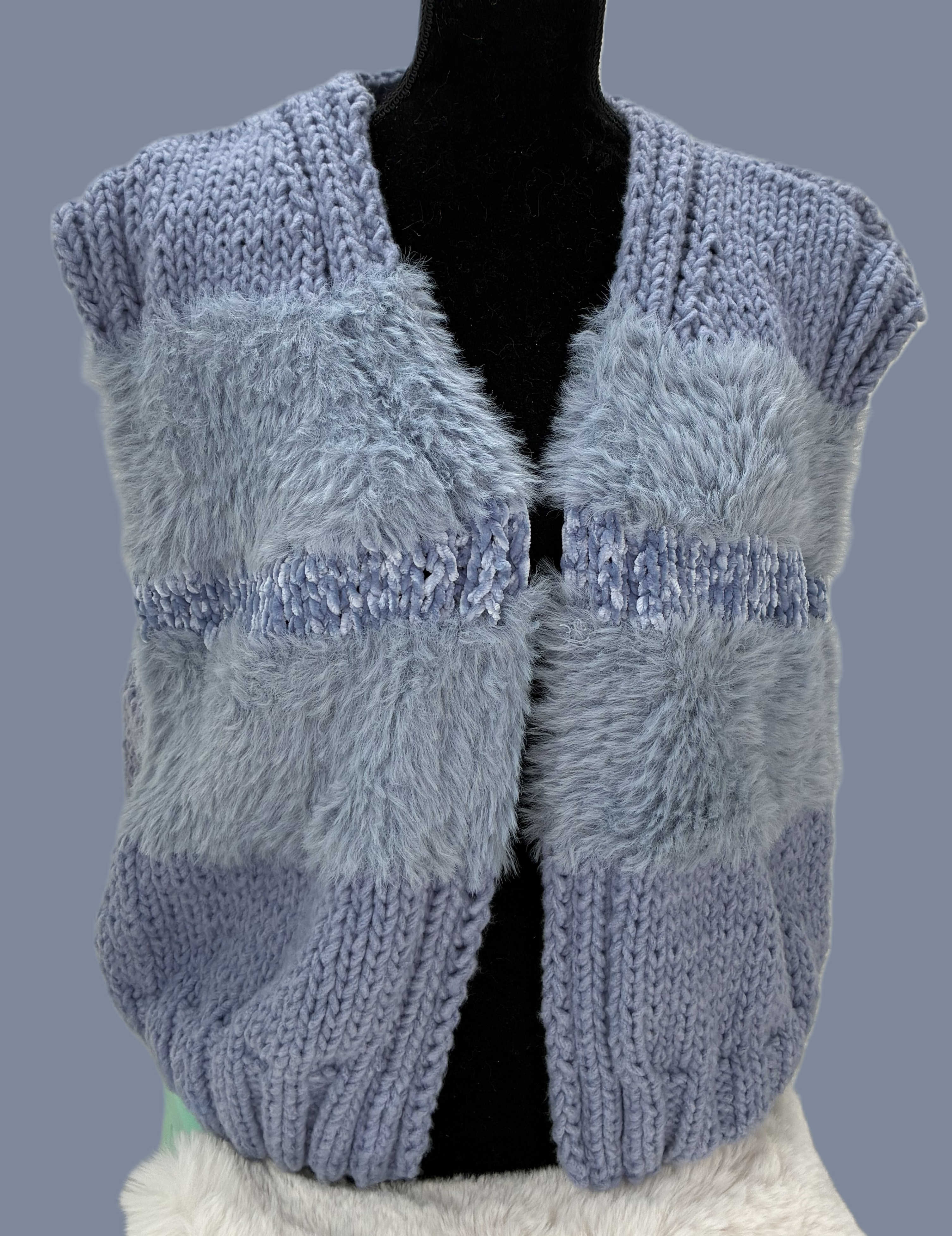 Chunky-knit sleeveless blue gray vest.