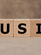 Wooden blocks spell "❤️ MUSIC+" on a neutral background, with a red heart symbol replacing "love." A warm, relaxed mood is conveyed.