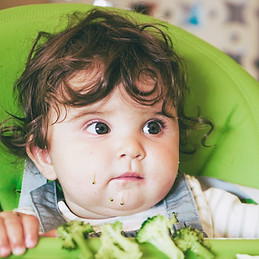 baby-eating-food-in-her-green-highchair-2021-09-02-12-43-49-utc_edited.jpg