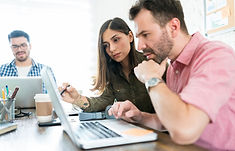 male-female-colleagues-planning-strategy-laptop-office-desk.jpg