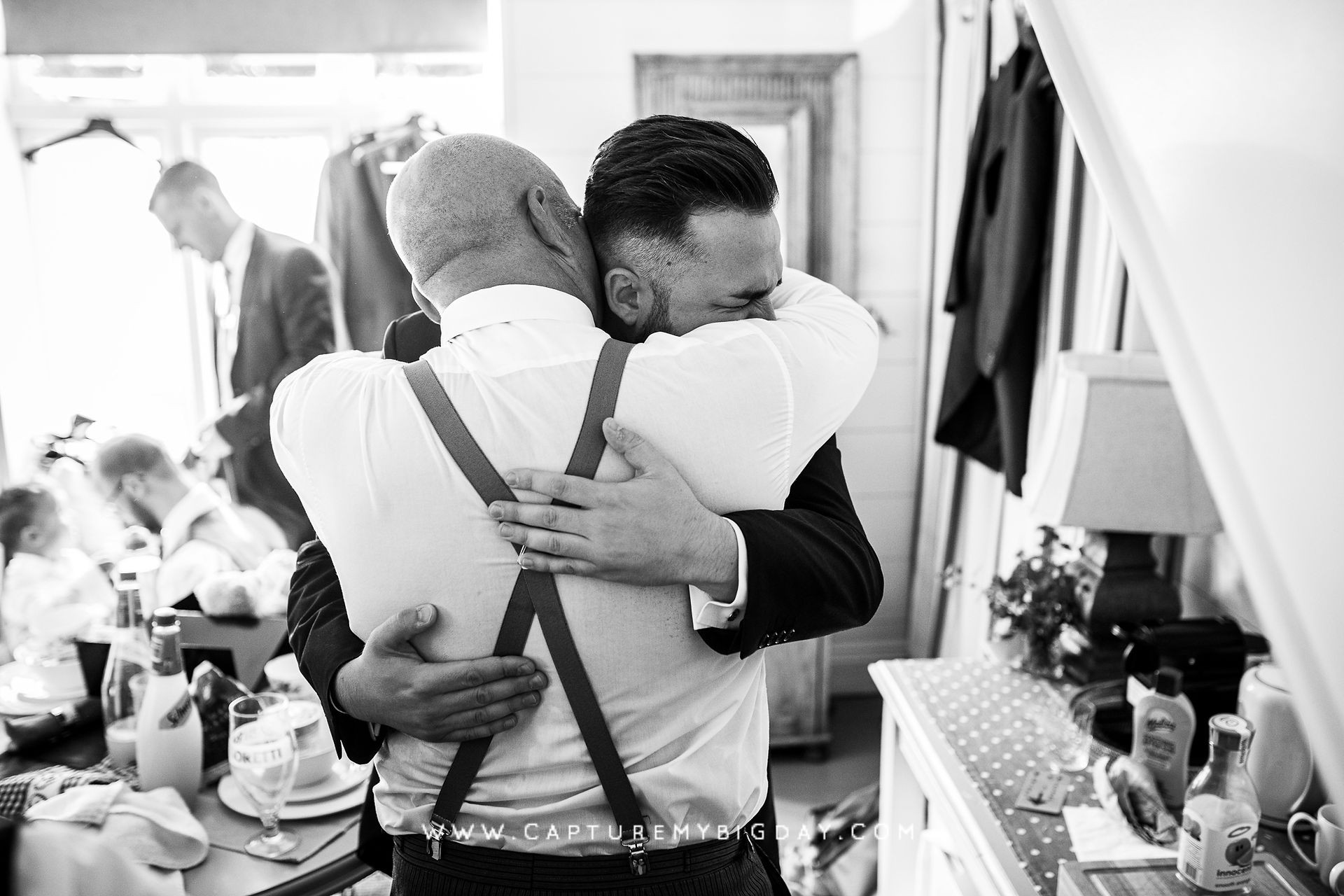 groom hugging