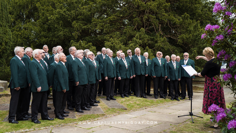 Male choir singing outside church