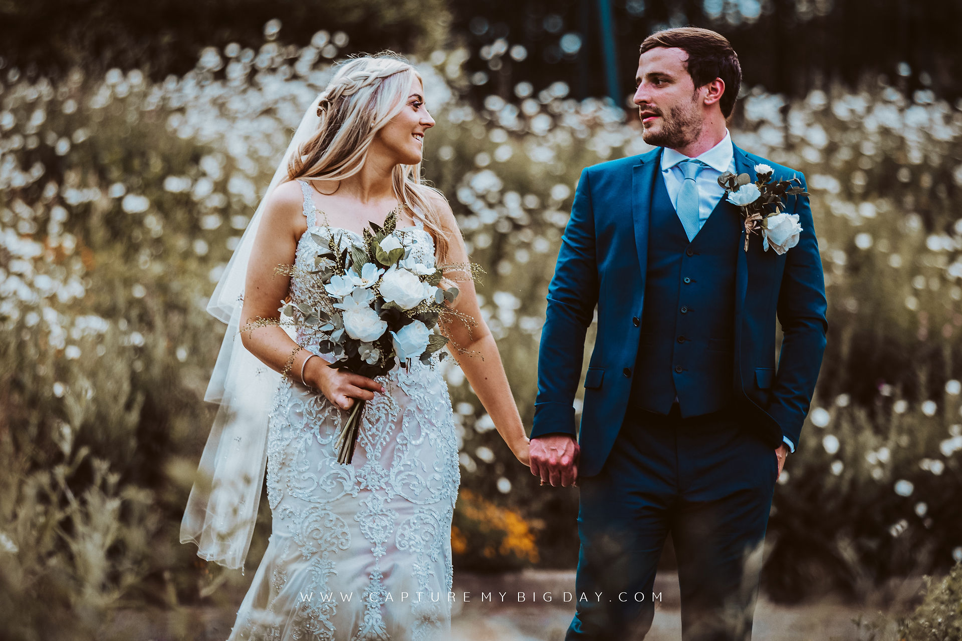 bride and groom walking in Sefton park