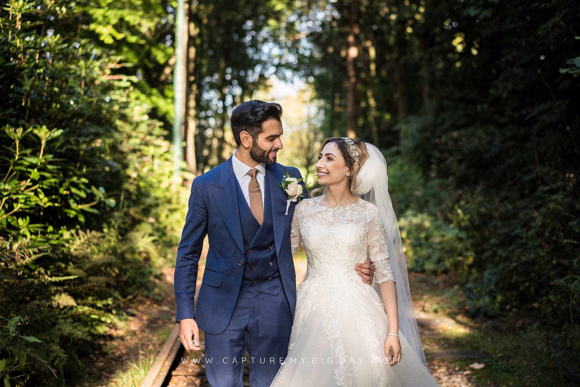 bride and groom go for walk n the woods