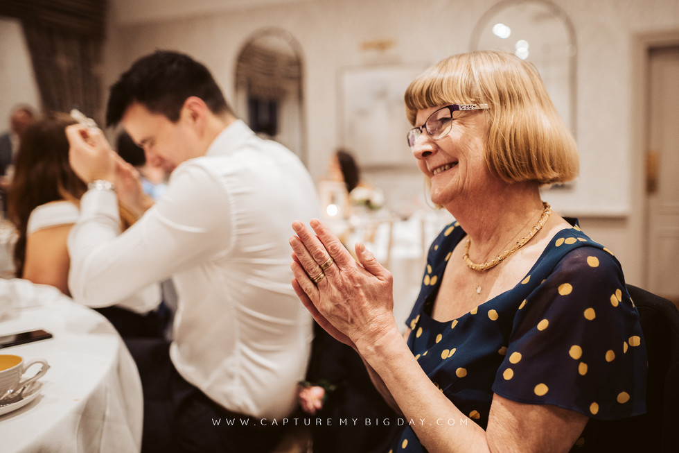 family clapping at wedding speeches