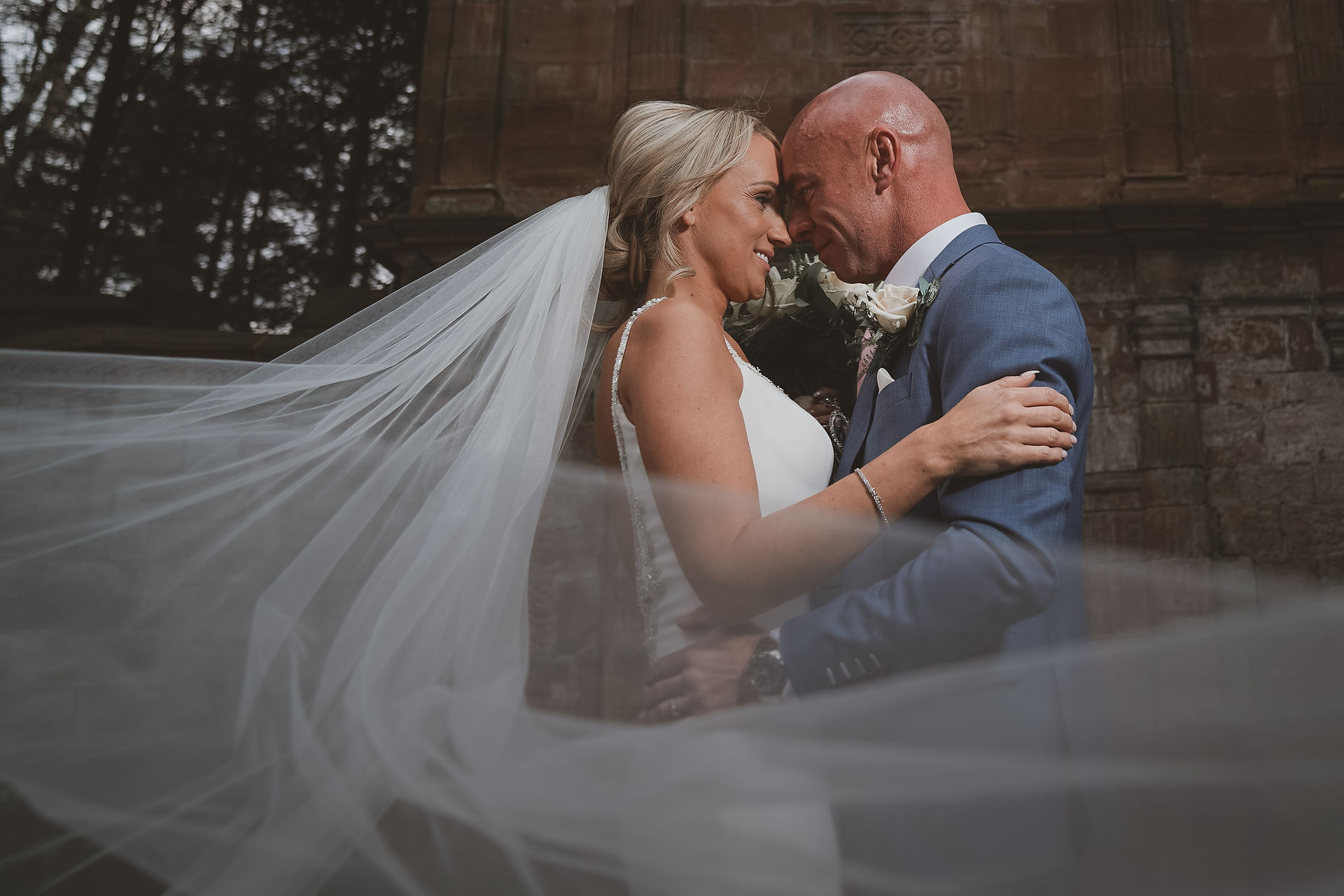 bride and groom with veil