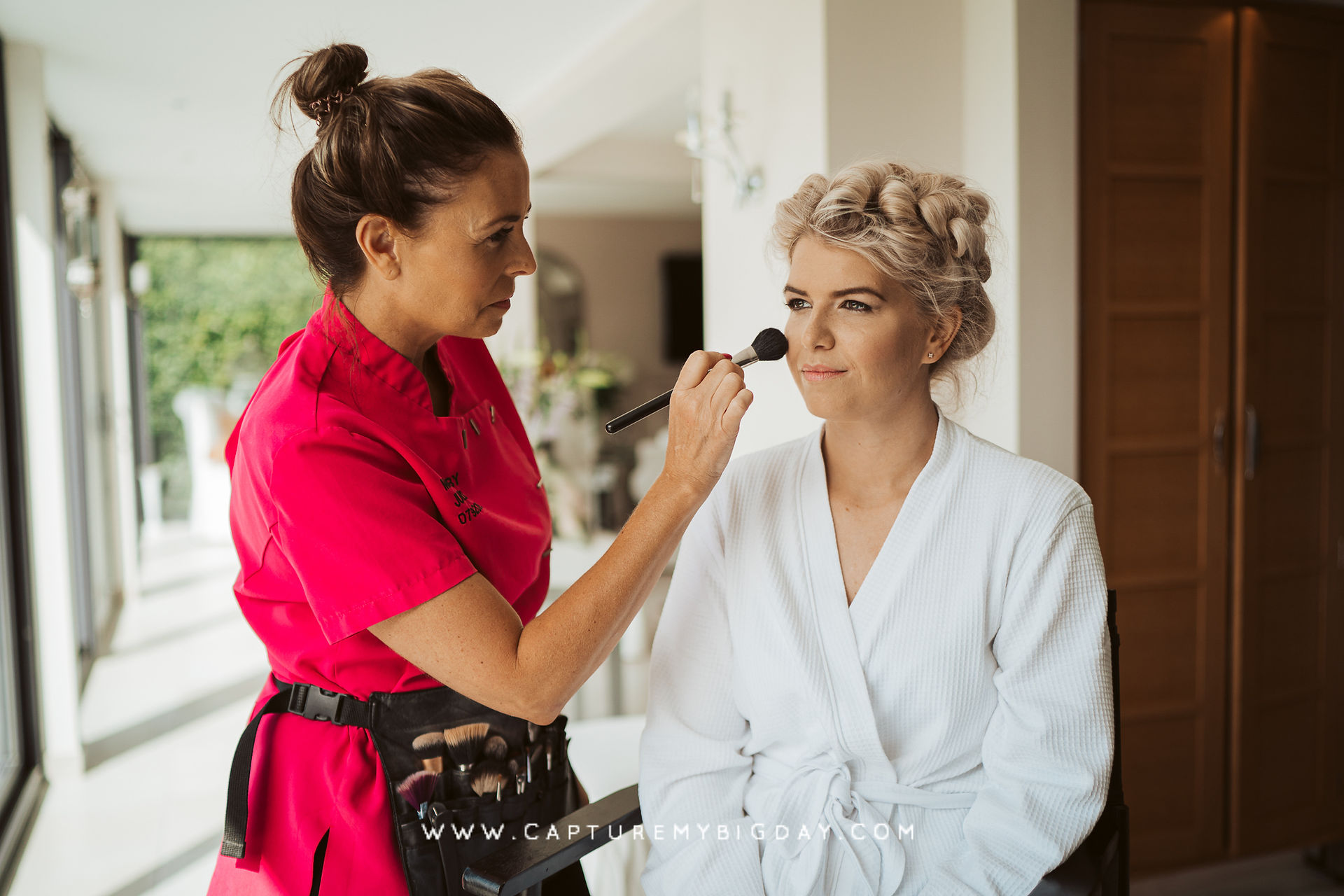 Bride having her makeup done in natural light
