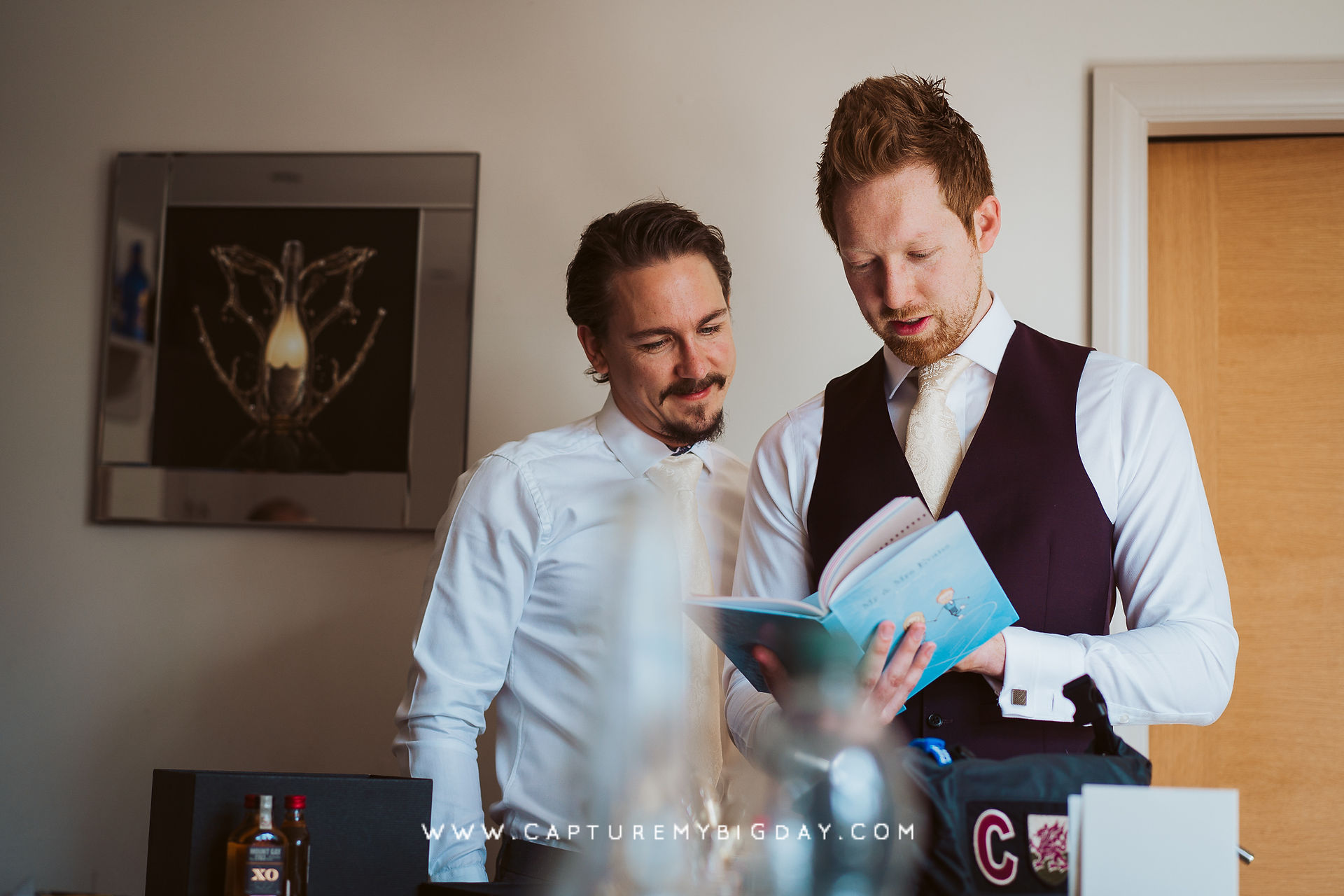 groom reading his gift book from bride