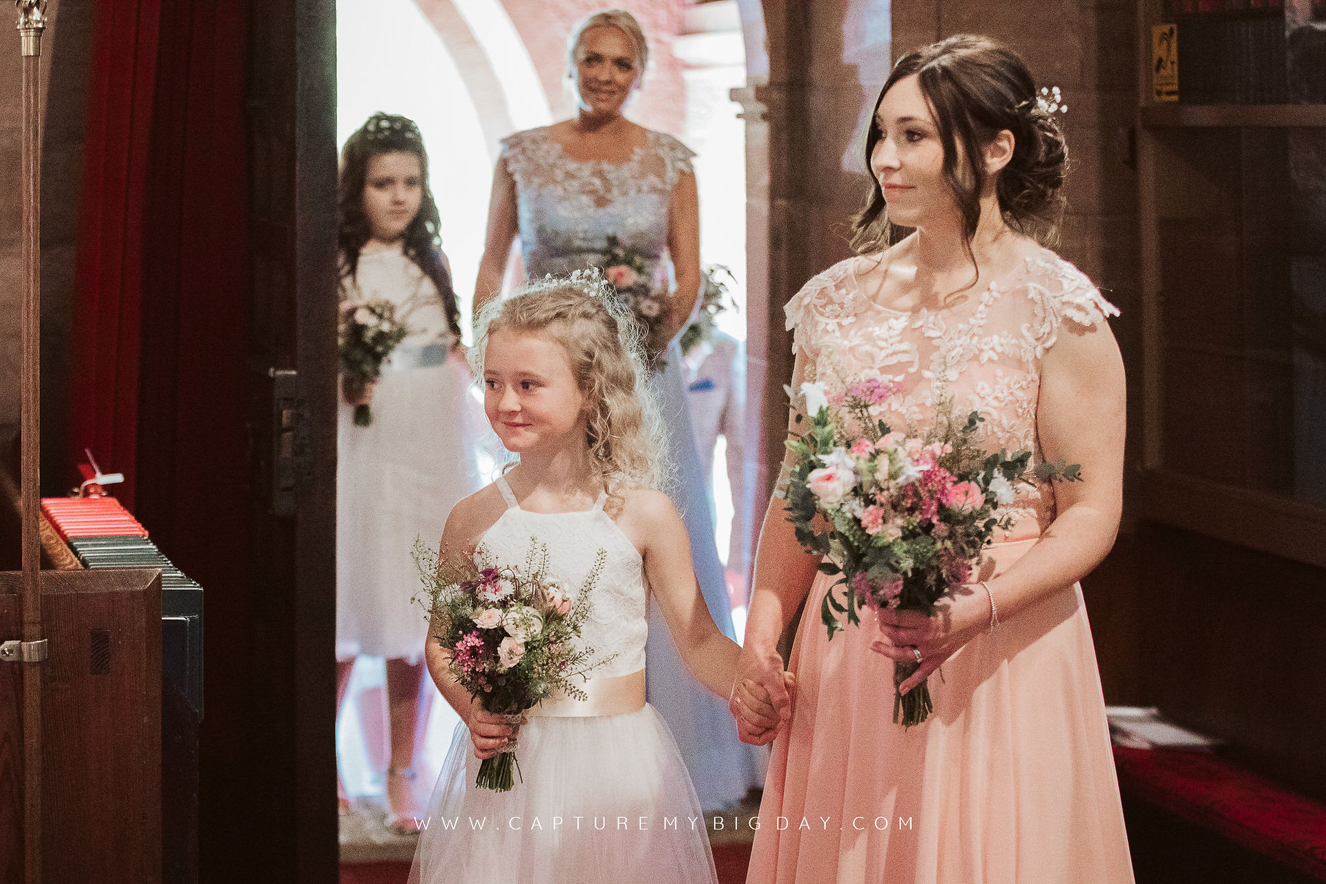 bridesmaids walking down the aisle