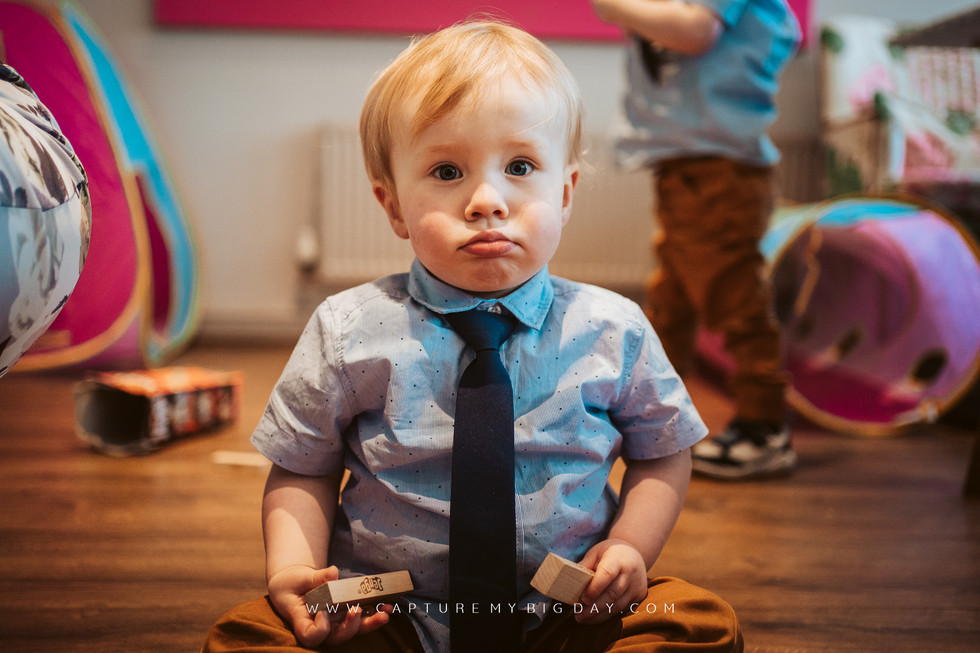 toddler playing with blocks at wedding