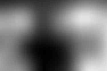 groom styling his hair in mirror