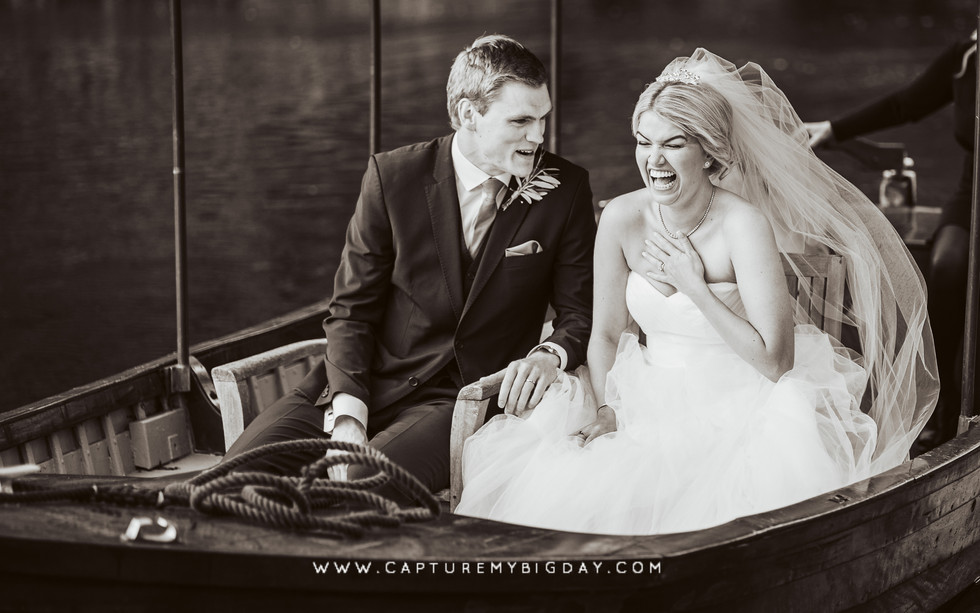 Bride laughing on boat with groom