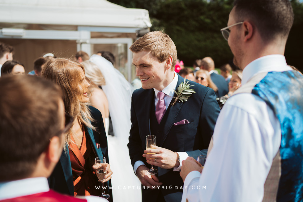 groom talking with wedding guests
