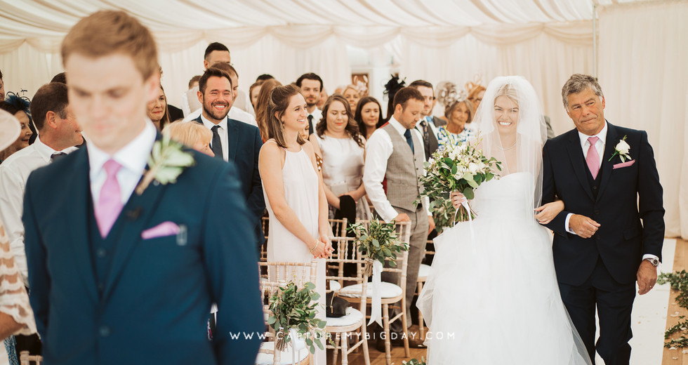 bride walking down the aisle with her father