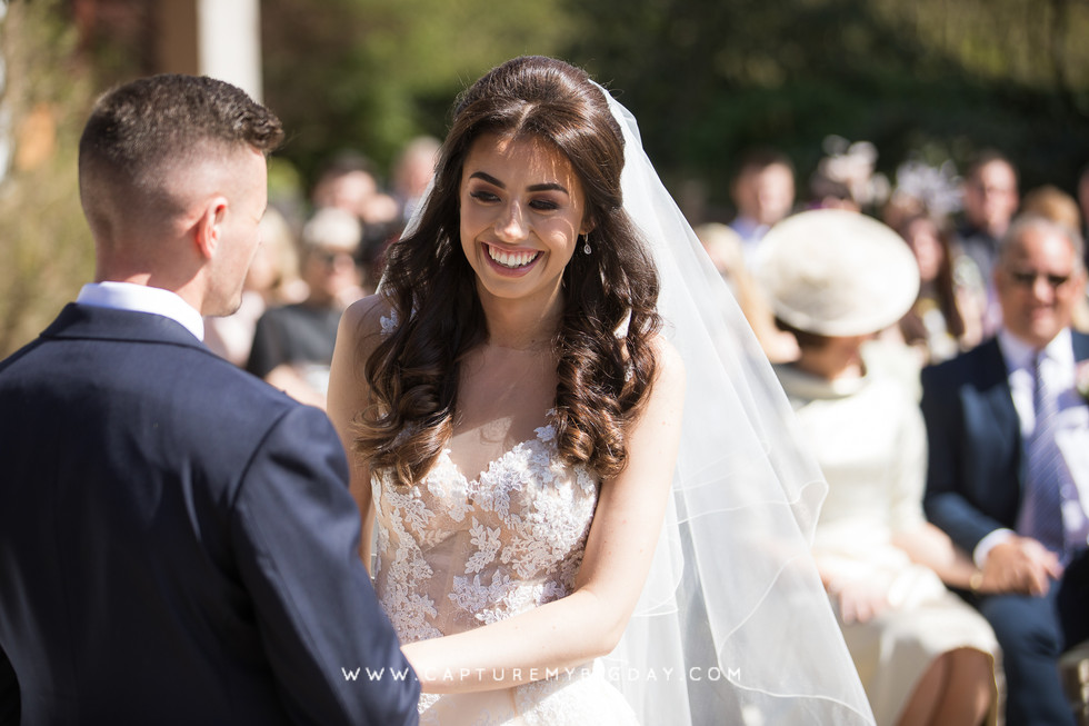 bride smiling at ceremony