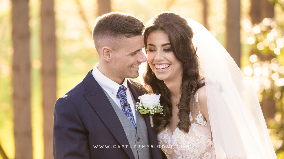 bride and groom smiling outside