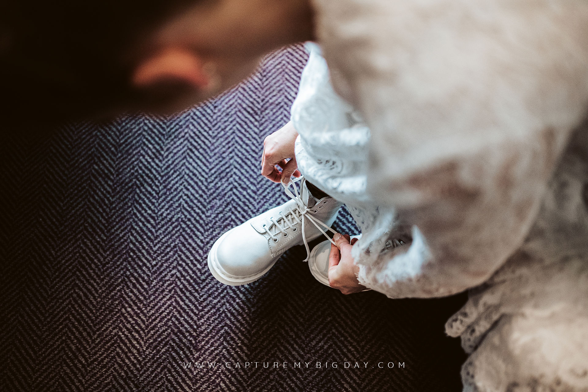bride putting her white Doc Martins on