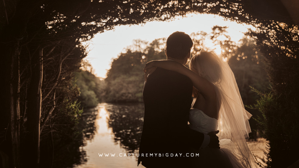 bride and groom under the trees