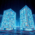 Futuristic cityscape with two glowing skyscrapers at night. Blue and cyan lights highlight the buildings. Streets show light trails.