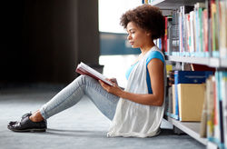 education, high school, university, learning and people concept - african american student girl read