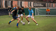 Charity Football match, the two teams clash during a tackle.