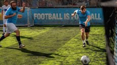Charity Football match player races towards the ball.