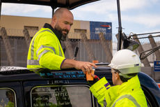 Hot coffee being served from a mobile taxi coffee shop to construction workers at an event in london.