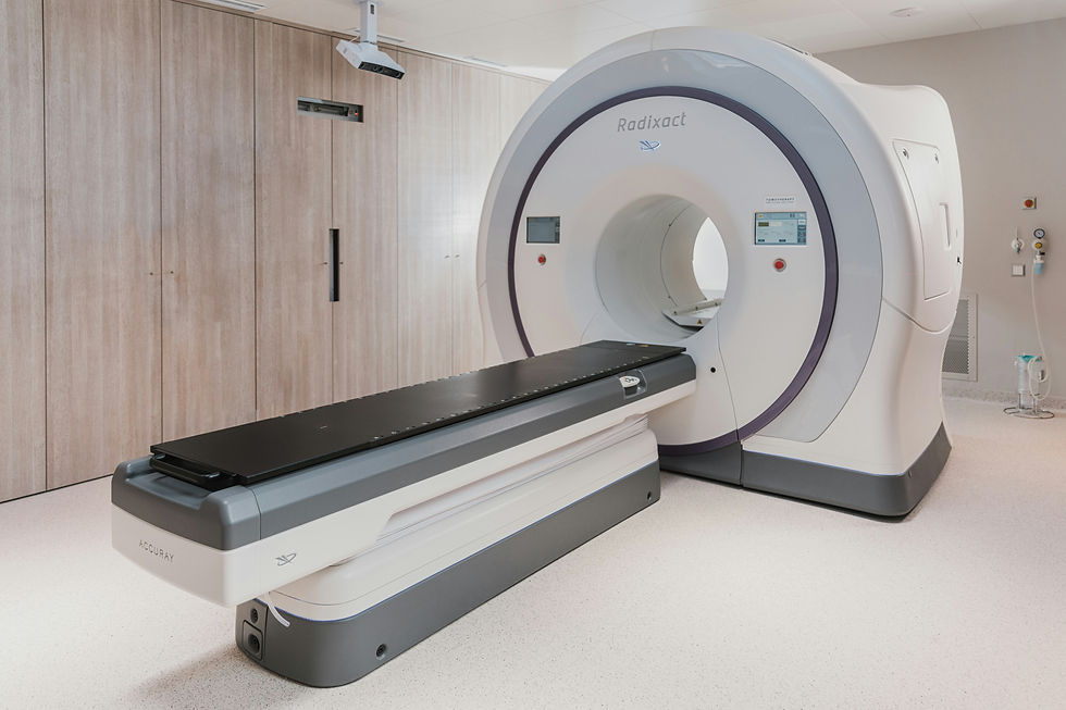 MRI machine and empty treatment table in a clean beige clinic.