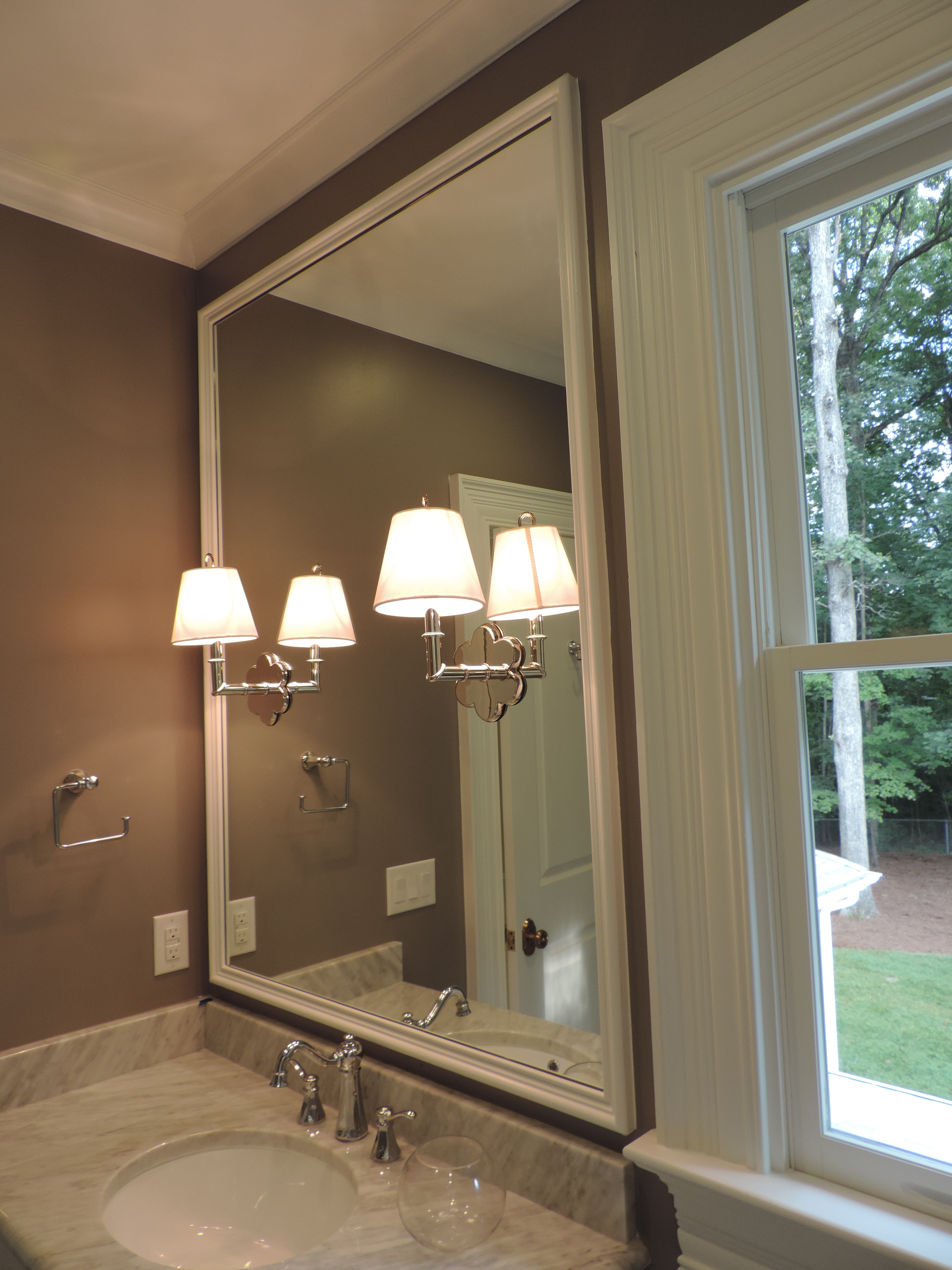 Polished Edge Mirror with Light Cut Outs set in Trimmed Frame