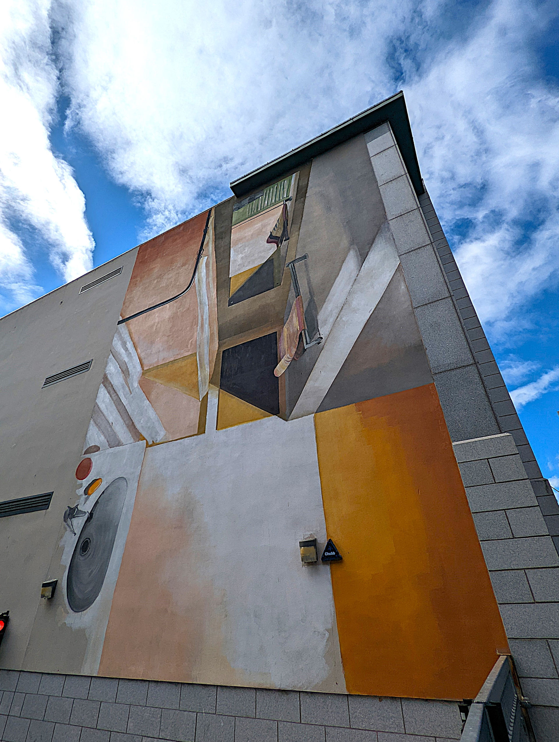 One of the Aberdeen street art murals on a building depicting geometric patterns.