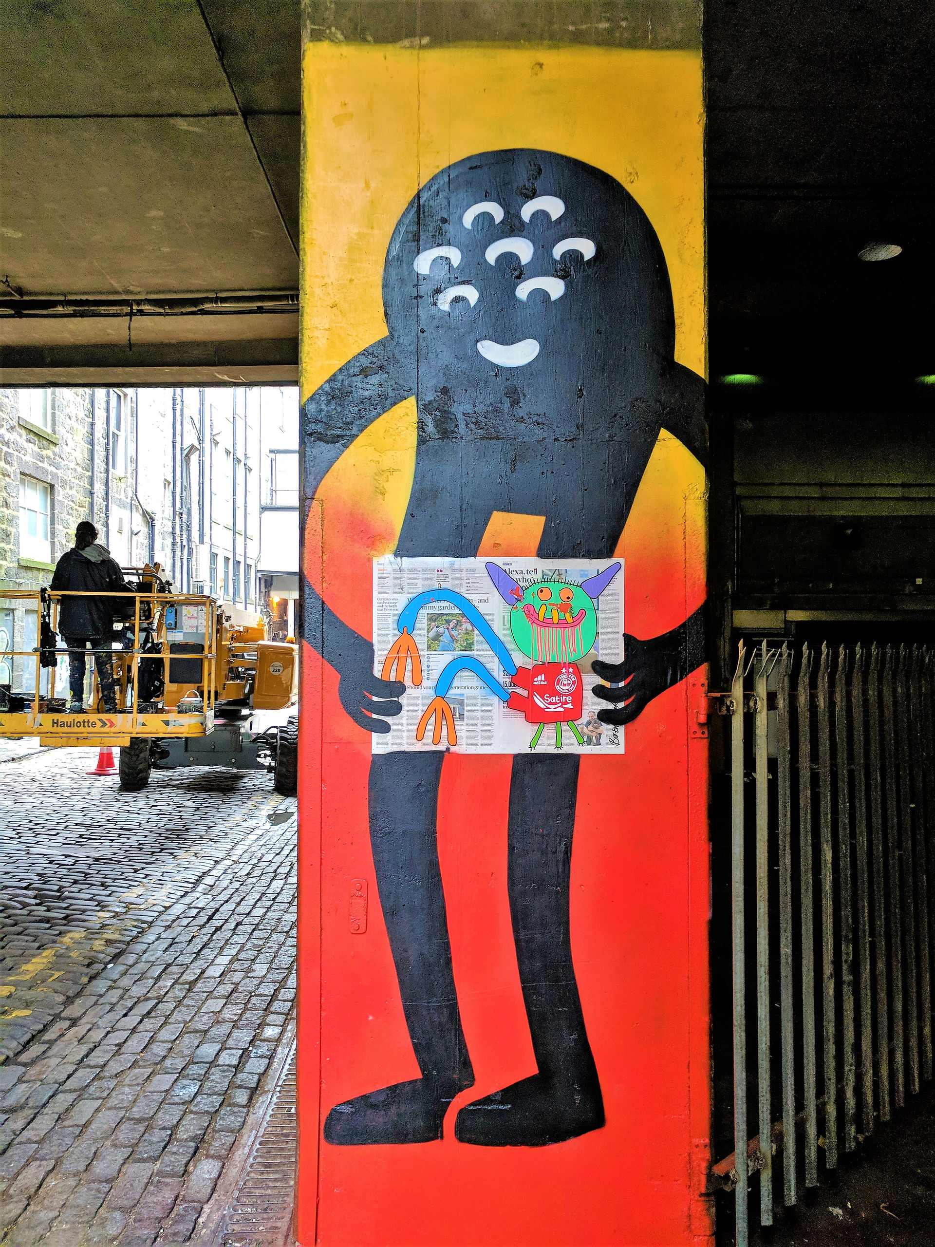 One of the Aberdeen street art murals on a building depicting colourful characters.